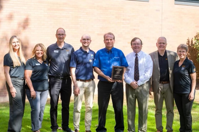 Reclamation's Kevin Kelly holding the award from the National Technical Institute for the Deaf.